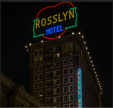 A large building with lights on it's side.