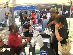 A group of people sitting around tables at an event.