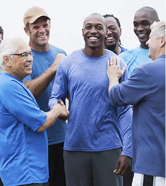 A group of men in blue shirts and hats.