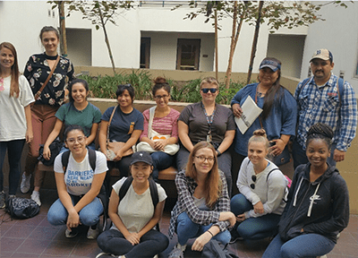 A group of people sitting on the ground.